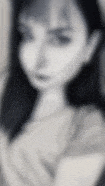 a blurry picture of a woman 's face with a white background