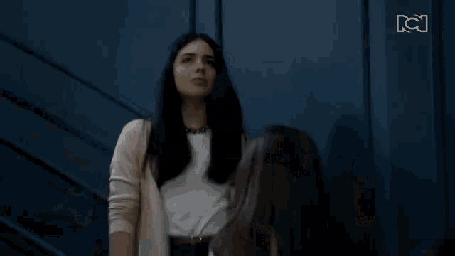 two women are standing next to each other and looking at each other