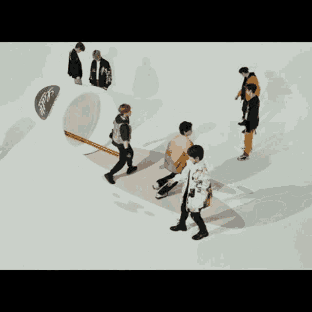 a group of young men are dancing on a white surface