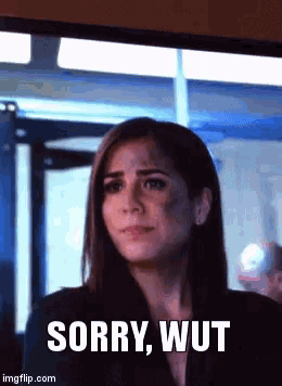 a woman says sorry wut in front of a screen