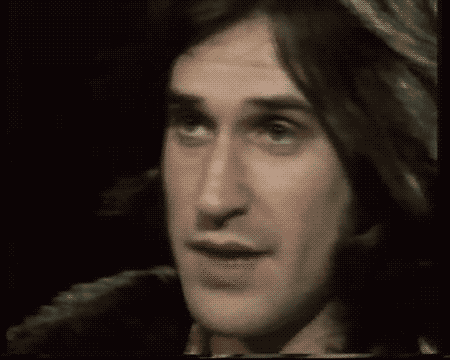 a close up of a man 's face with a slight smile on his face