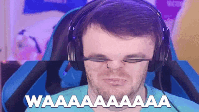 a man wearing headphones has the word waaaa written on his face