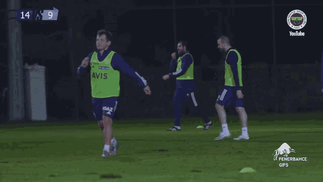 a soccer player wearing a yellow vest that says vis on it