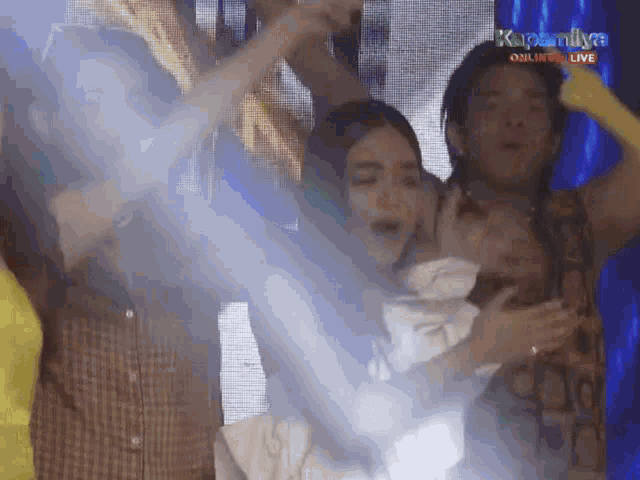a group of people are dancing in front of a screen that says kapamilya on it
