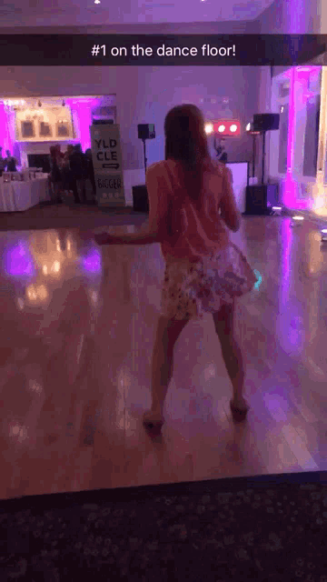 a girl is dancing on a dance floor with # 1 on the dance floor written on the bottom