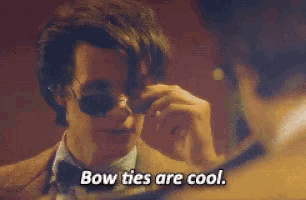 a man wearing bow ties is talking to another man