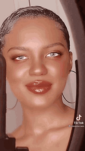 a close up of a woman 's face with tiktok written on the bottom right corner