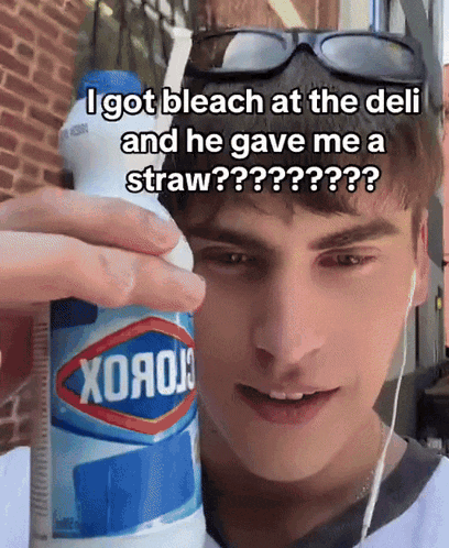 a man is holding a bottle of clorox and a straw