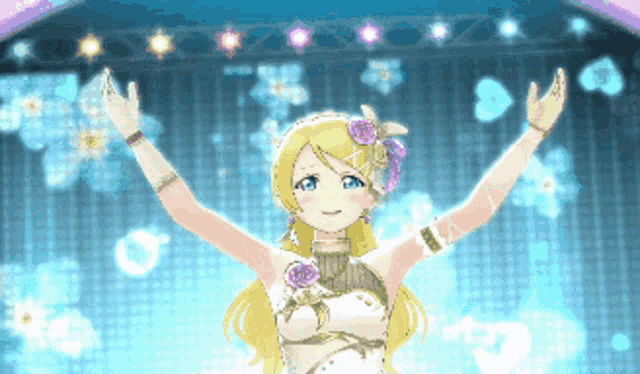 a girl with blonde hair is standing on a stage with her arms up