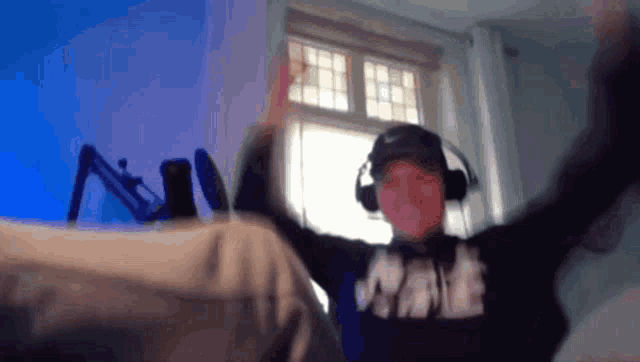 a man wearing headphones and a nike sweatshirt