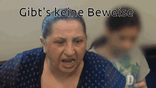 a woman in a blue polka dot shirt with gibt 's keine beweise in white letters