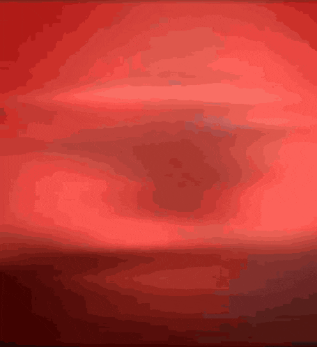a close up of a red background with a swirl in the middle