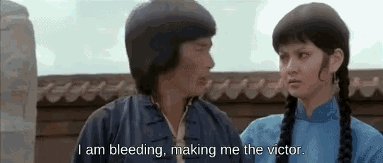 a man and a woman are standing next to each other and the man is saying i am bleeding making me the victor