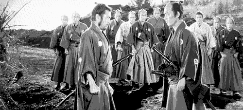 a group of samurai are standing next to each other in a black and white photo .