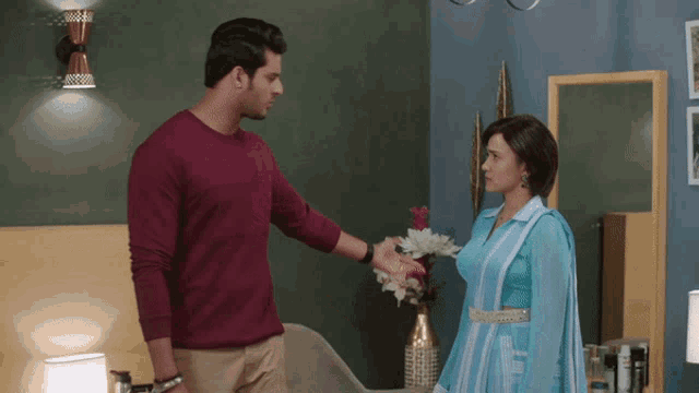 a man and a woman are standing in a room