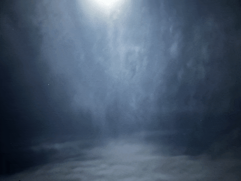 a dark room with smoke coming out of the ceiling
