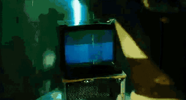 a close up of a television screen with a blue background and a picture of a face on it .