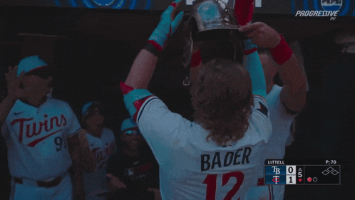 a baseball player wearing a helmet with bader 12 on the back of his jersey