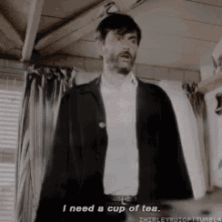 a man in a suit and white shirt is saying i need a cup of tea .