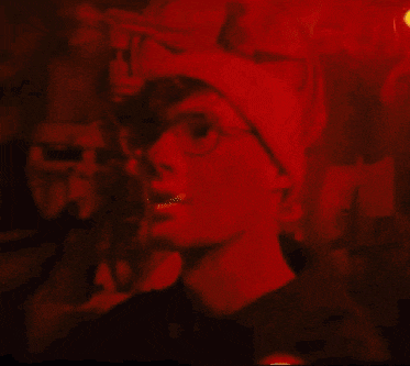 a person wearing glasses and a red hat with a s on it