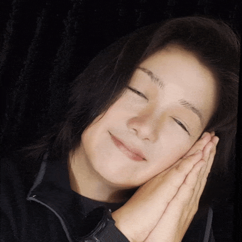 a woman with her eyes closed and a watch on her wrist