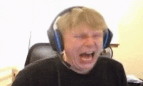 a man wearing headphones is making a funny face while playing a video game .