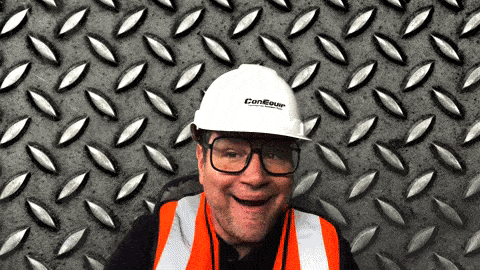 a man wearing an orange vest and a white hard hat that says conequip