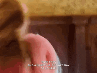a woman in a pink sweater is standing next to a man in a pink shirt .