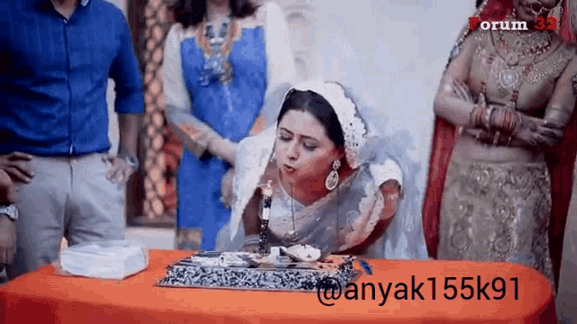 a woman blowing out a candle on a cake with the hashtag anyak155k91 on the bottom