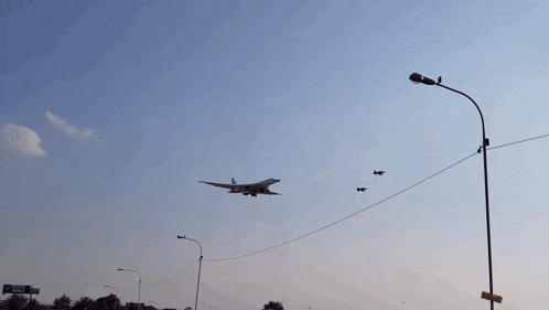 a fighter jet is flying in the sky with a rocket attached to it
