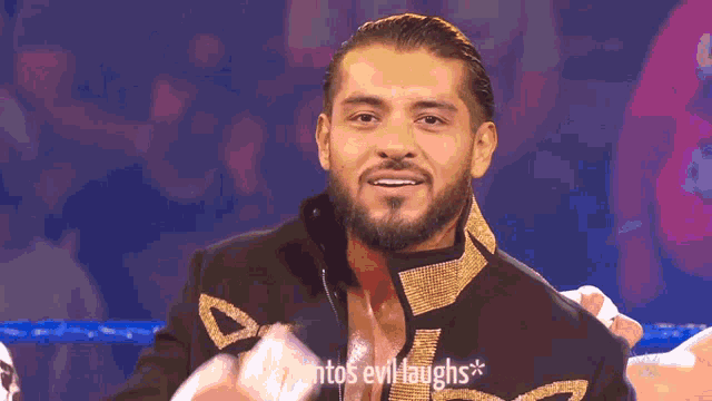 a man in a wrestling ring with the words " santos evil laughs " above him