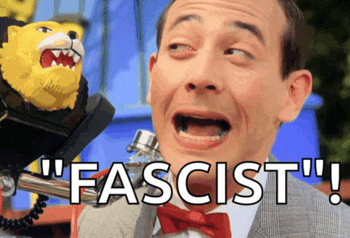 a man in a suit and bow tie says " fascist " next to a stuffed animal