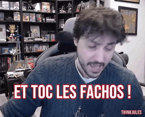 a man sitting in a chair with the words et toc les fachos written above him