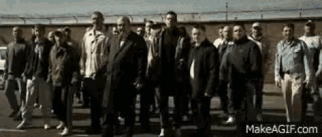 a group of men are standing next to each other in a line .