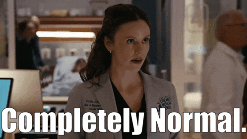 a woman in a lab coat stands in front of a sign that says " completely normal "