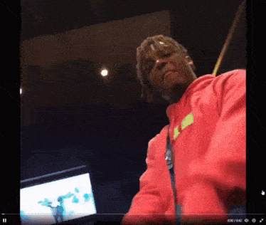 a video of a man in a red hoodie is being played on a screen