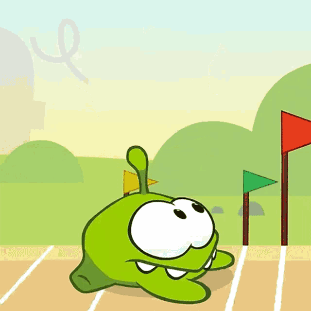 a green cartoon character is running on a track with flags in the background