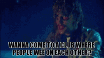 a man in a silver jacket says " wanna come to a club where people wee on each other "