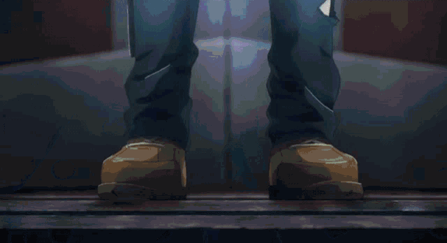 a person 's feet are shown in a blurry photo with a blue background .