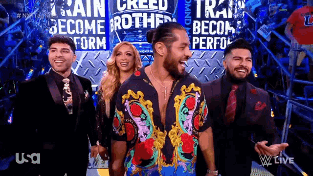 a group of people standing in front of a sign that says train creed become brothers
