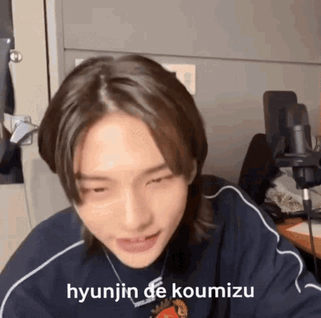a close up of a person 's face with the words hyunjin de koumizu written on it .