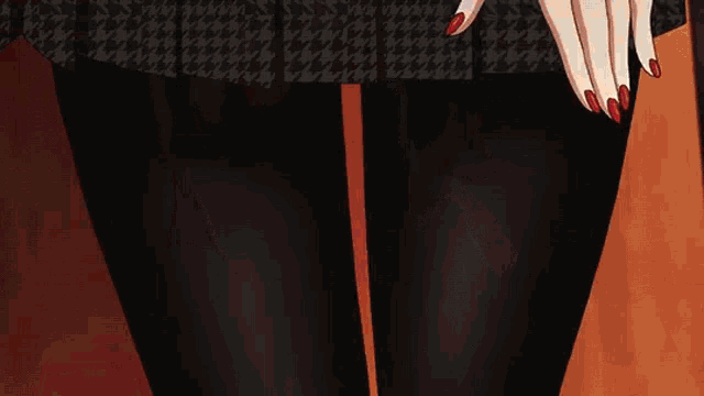 a close up of a girl in a red jacket with her hand on her face .