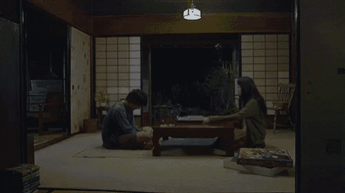 a man and a woman sit on the floor in a room