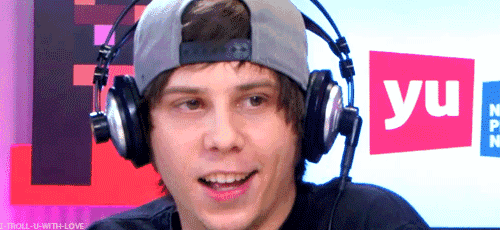 a young man wearing headphones and a hat with the word yu on it