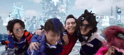 a group of young people are standing next to each other and smiling .