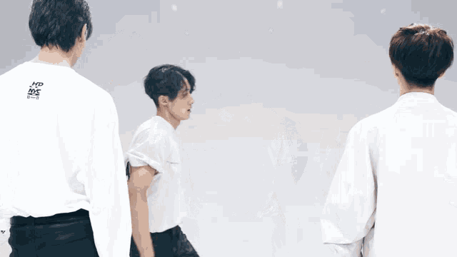 a man in a white shirt that says kpop on the back is dancing