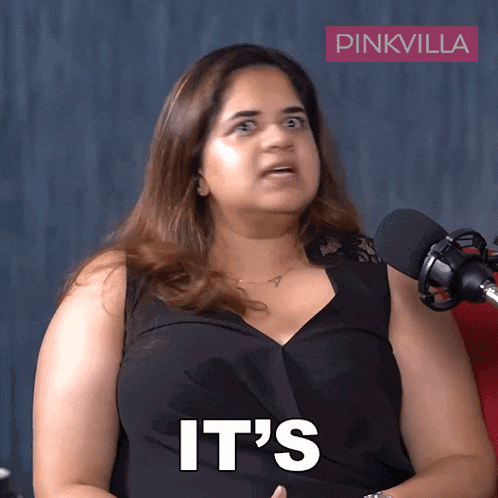 a woman sitting in front of a pinkvilla logo