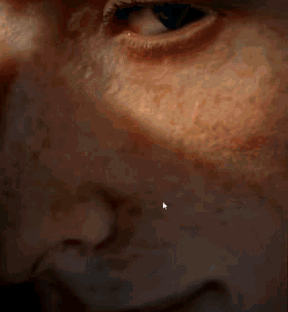 a close up of a person 's face with a white arrow pointing to a spot