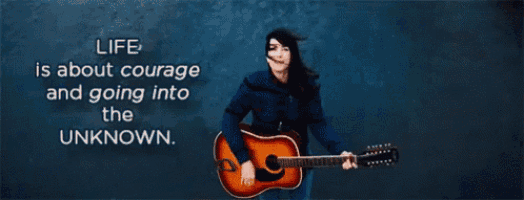 a woman holding a guitar with a quote about courage