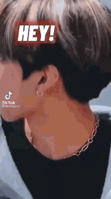 a close up of a person 's neck with the words hey ! written on it .